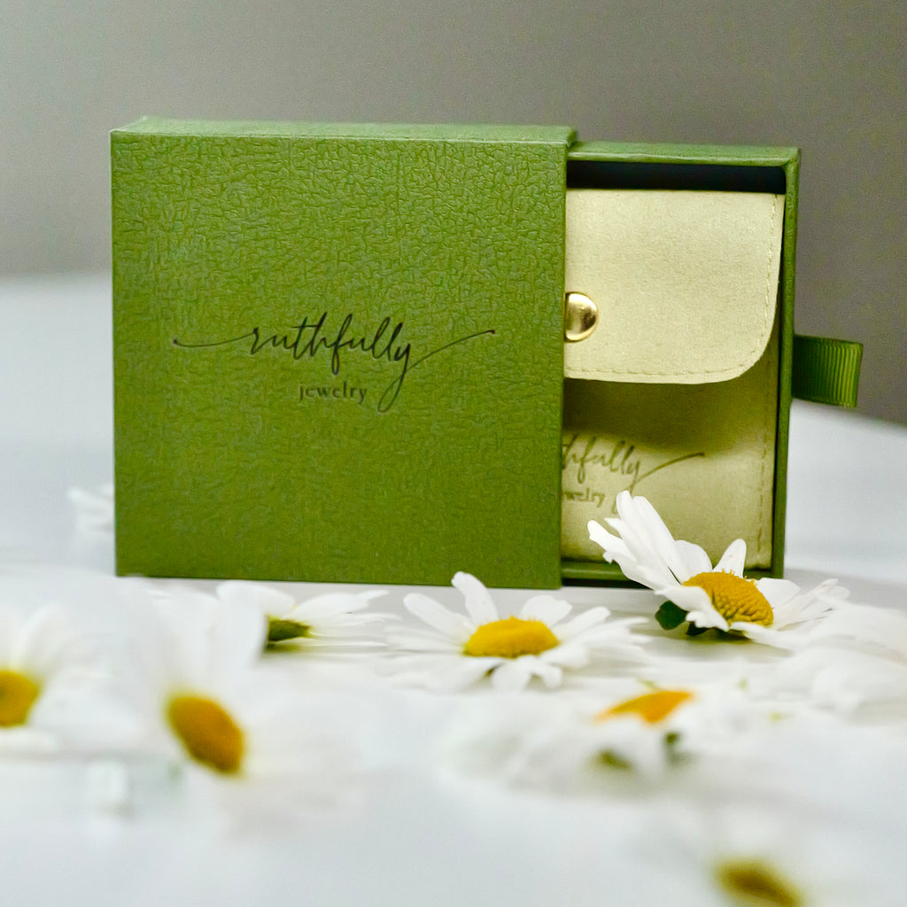 Sage green Ruthfully Jewelry gift box and suede pouch — premium faith-based jewelry packaging The story is in the details.